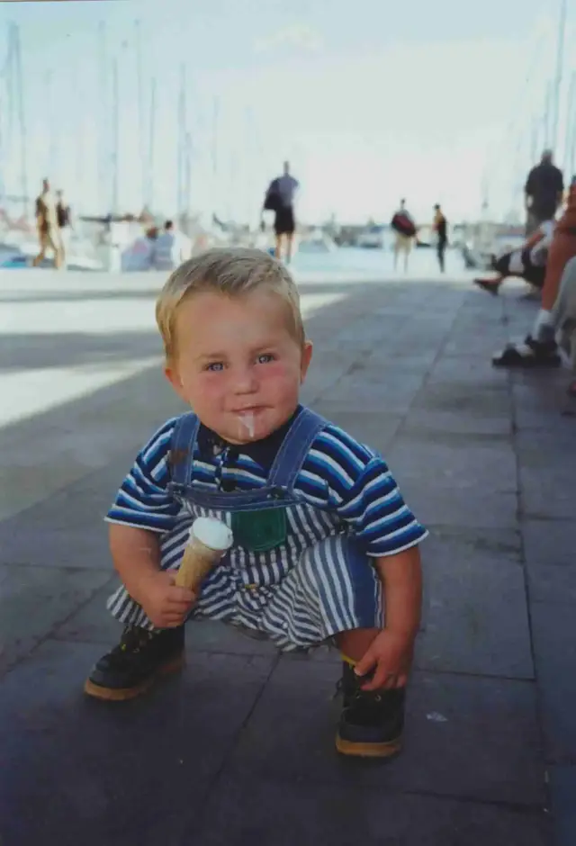 Jaro as a young child at a marina